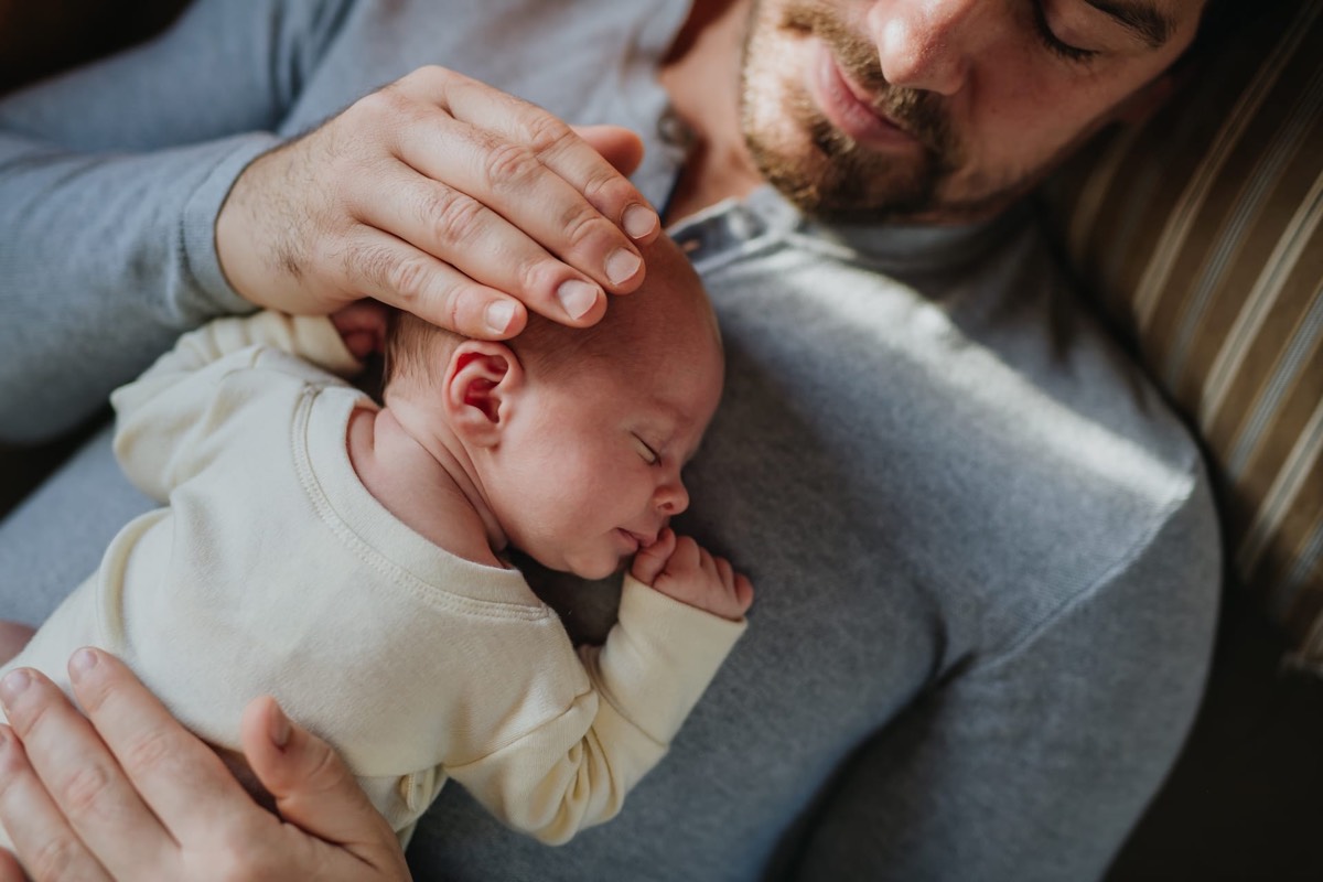 Vater hält sein schlafendes Baby im Arm